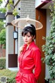 A woman in a red dress holding an umbrella.