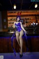 A woman in a bunny costume sitting at a bar.