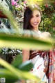 A woman in a colorful dress posing for a picture.